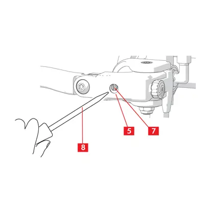 The flat-blade screwdriver is inserted into the hole until it engages the groove.